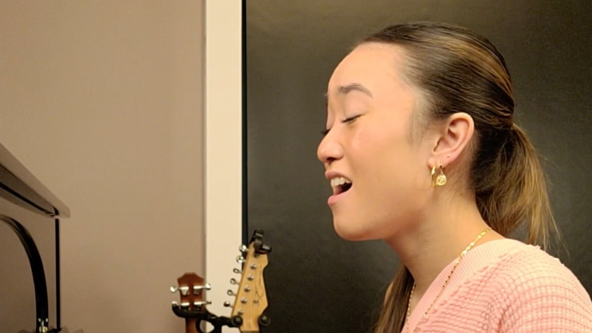 Girl singing by piano